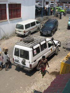 A vehicle intended for use in a back-country part of central Africa sports two local modifications:  1) A snorkel to allow the engine to aspirate under water, for use in driving across un-bridged rivers; and 2) a large sticker on the back window indicating “no weapons in vehicle.” (Image by Carl Friesen)