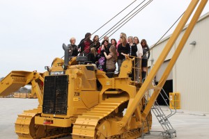 Several of PLM's staff pose on the new 72H pipelayer. 