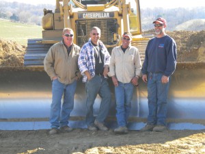 From left: Kevin Schrectengost, Adam Snover, Don Richie and Brandy Truba pose in front of a Caterpillar D-6 dozer. 