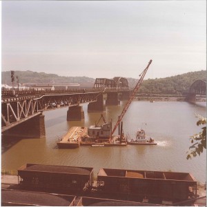 Otis crews worked on several bridge crossings over the Monongahela River near Pittsburgh on a 1970s project for Carnegie Gas. Hourly a trainload of cars carrying molten steel crossed the bridge and forced workers to climb down to escape the heat. They also installed pipe under a crossing where trains turned around.