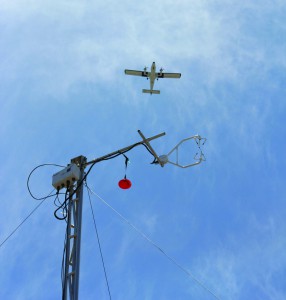 An observational craft flies over the methane and meteorological sensing towers deployed at the south methane controlled-release site. 