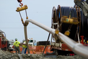 Pulling steel pipeline under the York River from the North Shore.