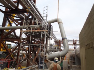 Crews move piping into place for recirculation at a pump station. It’s part of an effort to increase the temperature of crude oil during transit in winter months.