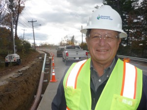 Summit Natural Gas of Maine President Michael Minkos stands beside a stretch of pipeline that is part of an effort to reach 52,000 customers in the next five years.