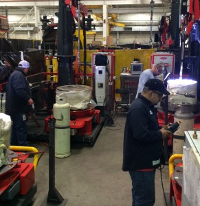 ValvTechnologies staff running parts for 8-inch 2500-pound valves on the compact cladding machines.